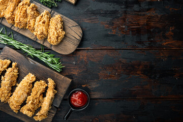 Southern fried chicken on dark wooden background, flat lay, with space for text