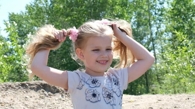 Happy child girl having fun outdoors. Portrait of smiling little girl.  Enjoying childhood