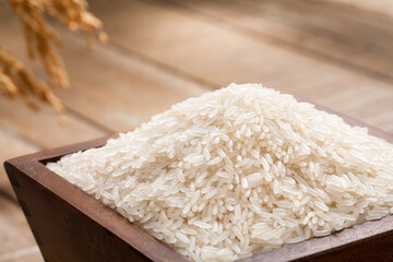 close up of fragrant rice in a wood bucket.