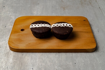 Two chocolates close up on a board