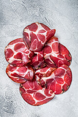 Coppa Cured ham on kitchen table. White background. Top view