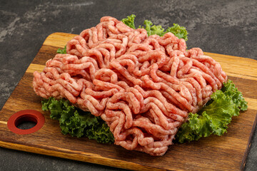 Raw pork minced meat over board