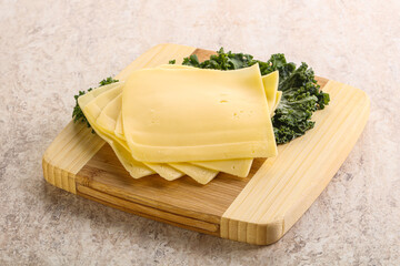 Sliced Gouda cheese over board