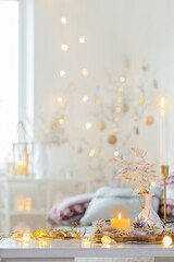 christmas home decorations with candles in white interior