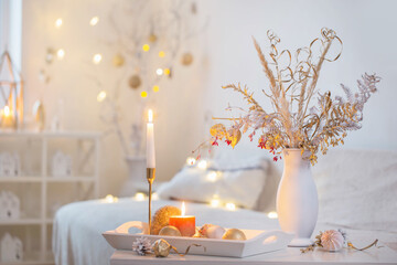 christmas home decorations with candles in white interior