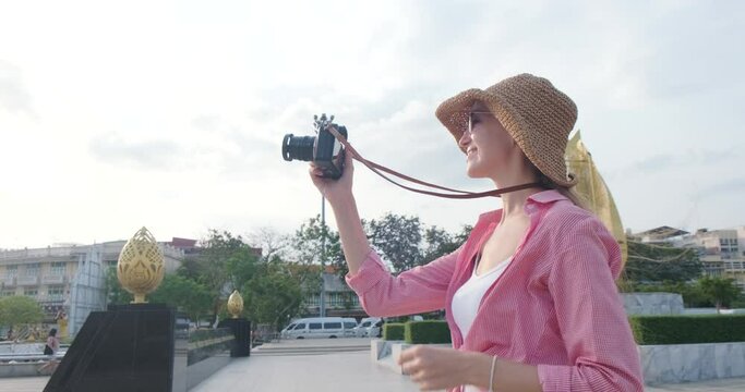 Women take photo in local city while travel in center of Bangkok temple town Thailand 