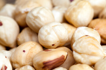 peeled and roasted hazelnuts on a wooden table