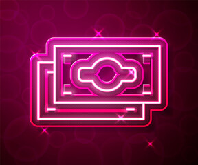 Glowing neon line Stacks paper money cash icon isolated on red background. Money banknotes stacks. Bill currency. Vector