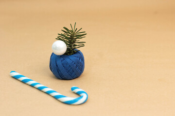 White and blue sugar cane next to curly blue embroidery thread with white pearl and green herb inside