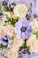 Beautiful bouquet of mixed flowers with ranunculus clooney hanoi in woman hand. Floral shop concept . Beautiful fresh cut bouquet. Flowers delivery
