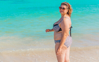 Fototapeta premium Plus size American woman at beach, enjoy the life. Life of people xxl size, happy nice natural beauty woman