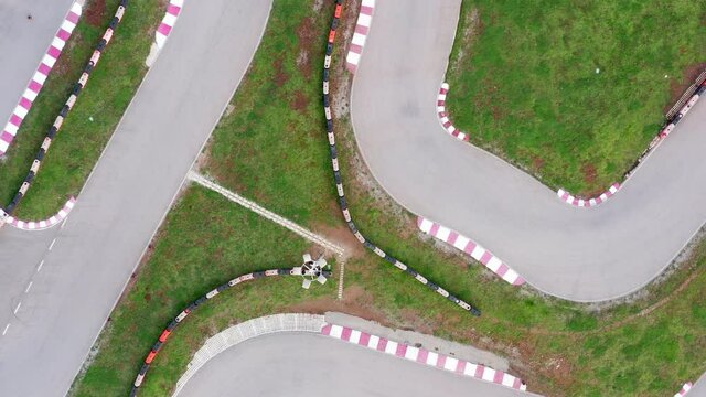 Kart circuit - race track for go cart, motorcycle, bike or radio-controlled model racing. Aerial drone top view of the raceway or speedway route with curves.