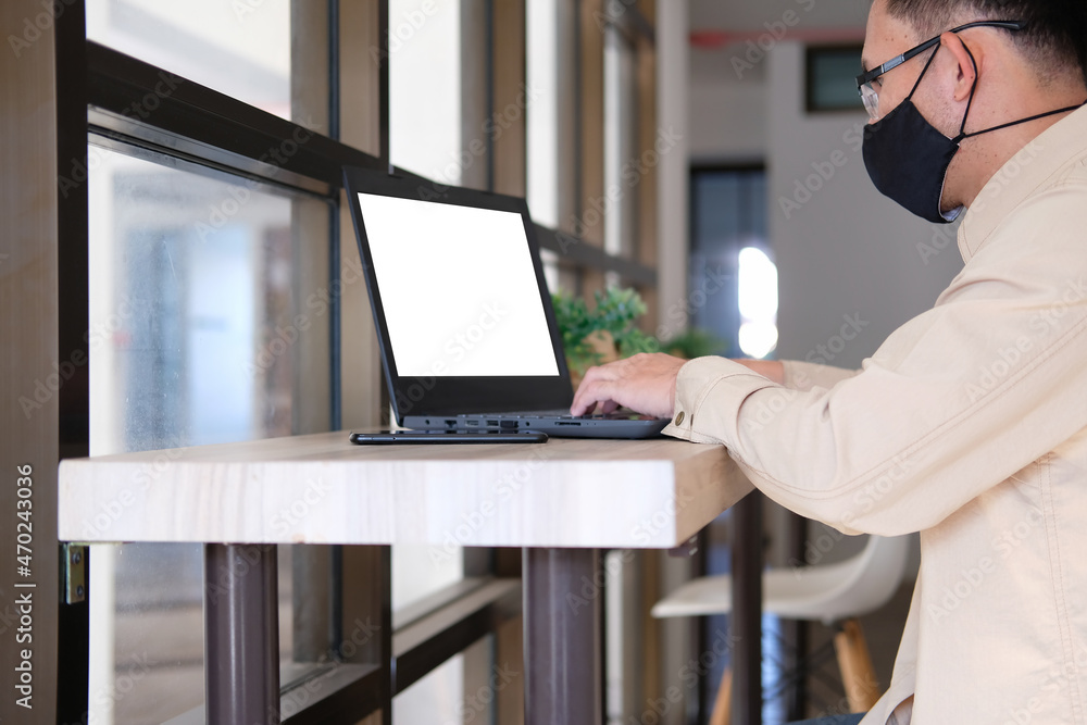 Poster businessman types on a computer keyboard at a wooden desk. banking and strategy development a financ