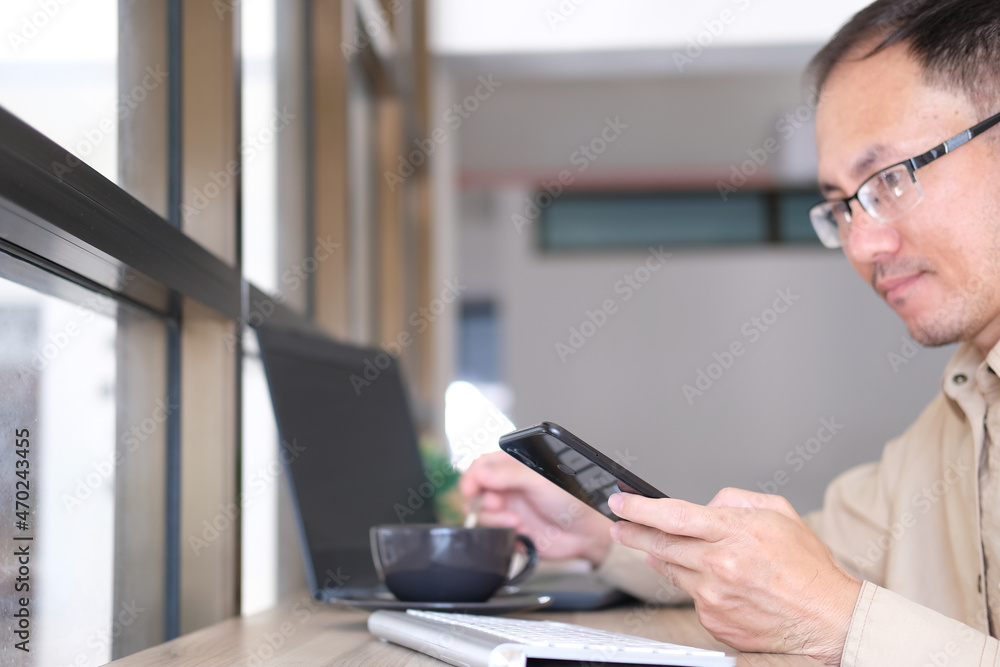 Poster businessman types on a computer keyboard at a wooden desk. banking and strategy development a financ