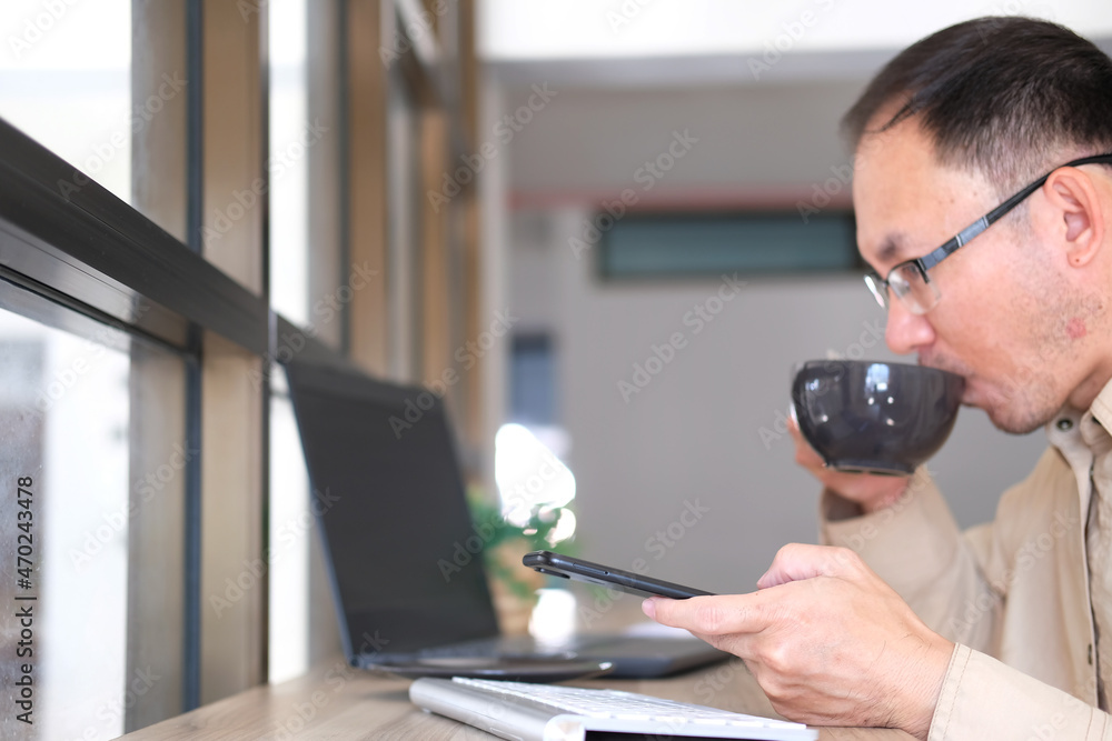 Poster businessman types on a computer keyboard at a wooden desk. banking and strategy development a financ