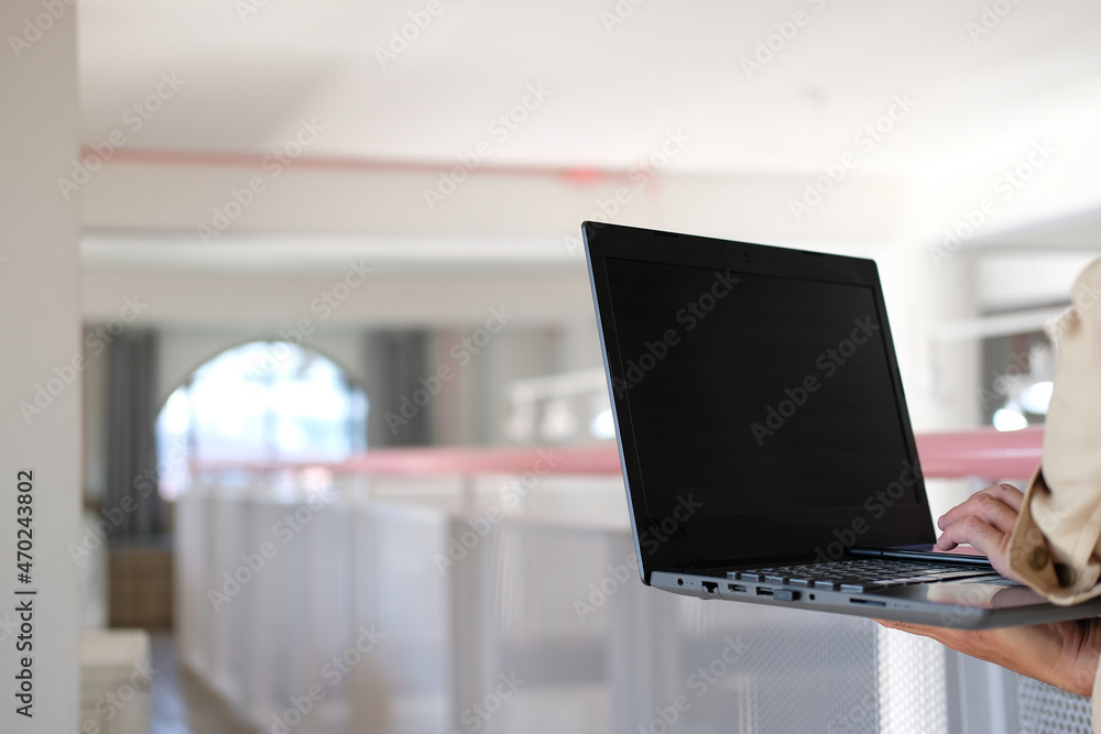 Aufkleber man typing on a laptop computer while sitting at a white office work table with a cup of coffee and 