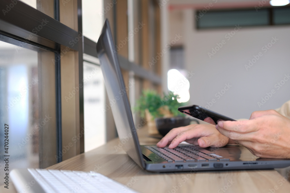 Aufkleber man hands working on modern laptop. office desktop and using smartphone