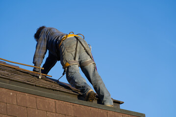 Worker cleaning rain pipe on a beautiful autumn day. Photo taken November 12th, 2021, Zurich, Switzerland.