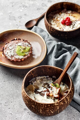 Healthy breakfast bowl: oatmeal with banana, kiwi, almonds, raspberries and chia seeds