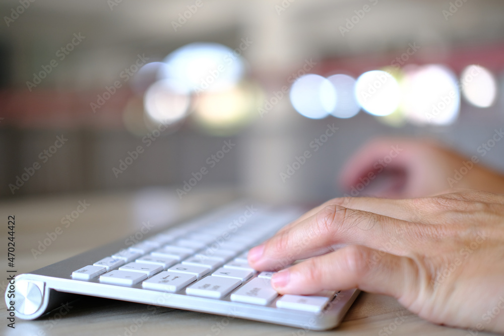 Poster man hands on the keyboard of a personal computer in the office or at home, suitable for both freelan