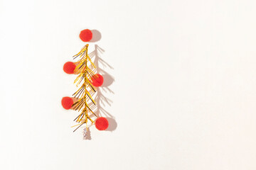 Christmas gold tree made of tinsel on a white horizontal background. Christmas tree decorated with...