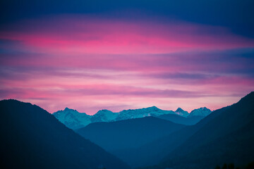Naklejka na ściany i meble Fantastic mountain landscape on background of pink and a dramatic sunset