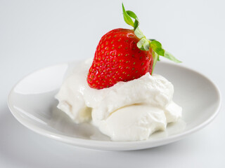 Strawberries with whipped cream on a white background