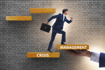 Crisis management concept with climbing businessman