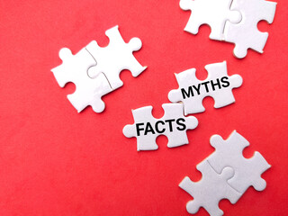 White puzzle with text FACTS MYTHS on a red background.