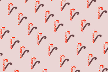 Pattern with Christmas candy canes on pastel pink background. Getting ready for the New Year....