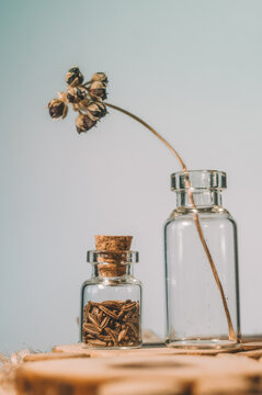 Glass bottles with corks containing and cumin seeds. Selective focus