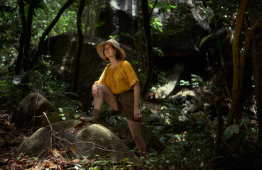 Girl with a hat in the jungle. Travel, adventure, expedition.