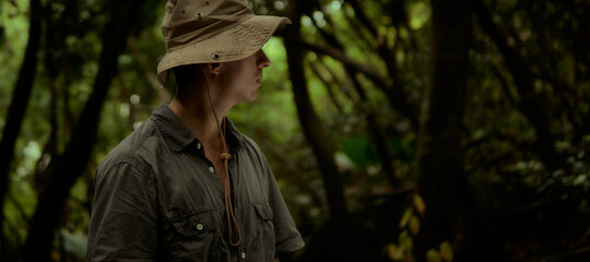 The guy with the hat is exploring the jungle. Travel, adventure, expedition.