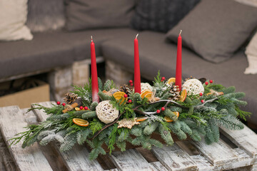 Christmas table decoration with candles, globes and cones