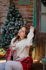 Christmas time for a beautiful young woman with long dark hair happy in the winter street holding gift