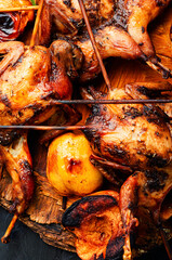 Quail fried on skewers with apples
