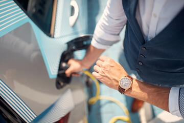 Fast charging of an electric car. man charging his electric car.