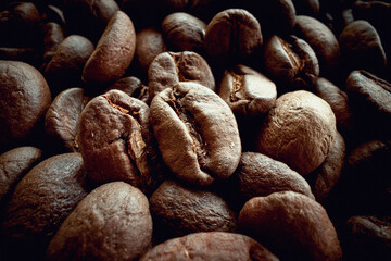 Zoomed in a bunch of roasted coffee beans. Coffee, beverage, producing