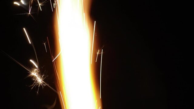 Close up flames ignite and sparkles isolated on black background. Fireworks flame and sparks on black background