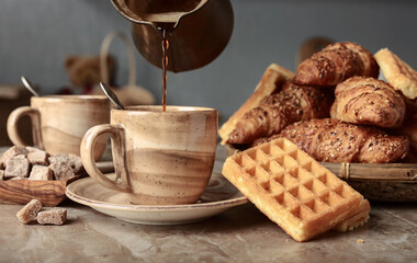 Breakfast with black coffee and fresh pastries