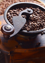 close-up of old coffee grinder and roasted coffee beans