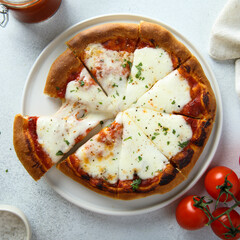 Homemade pizza with mozzarella and tomato sauce