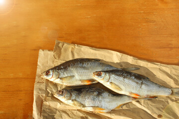 Dried dried fish for beer on a wooden table. Seafood on brown paper