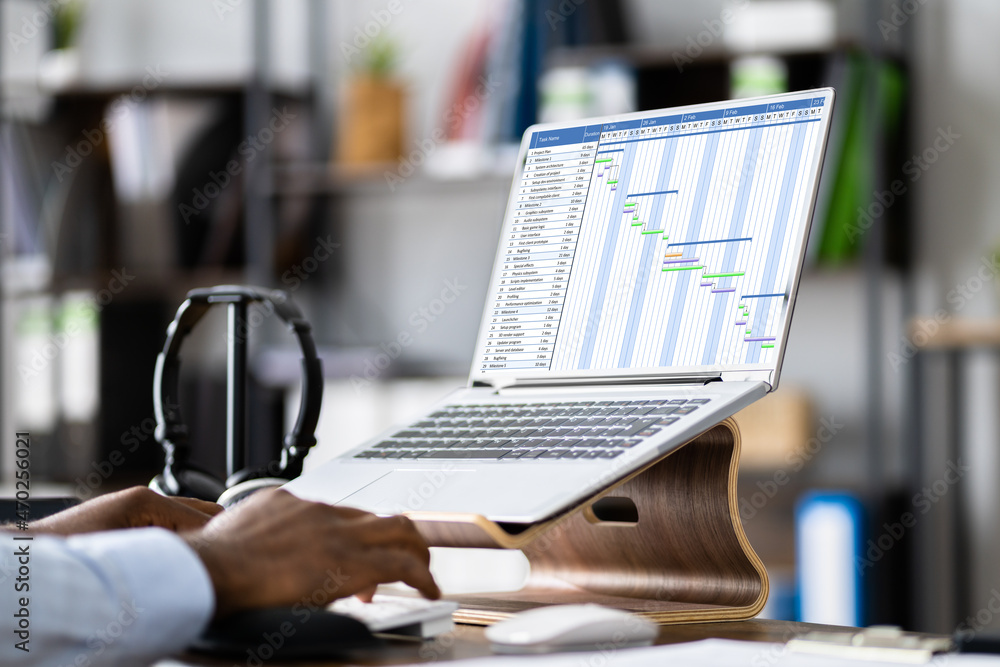 Poster businessman working on gantt chart using computer