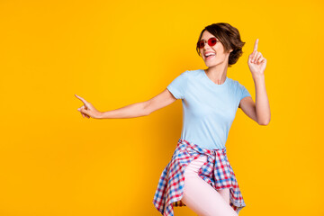 Photo portrait of careless woman dancing with shirt on waist isolated on vivid yellow colored...