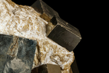 Macro stone Pyrite mineral in rock on a black background