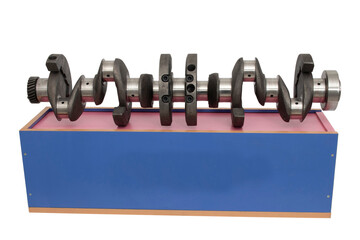 Crankshaft with wooden box. Industrial background.