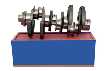 Crankshaft with wooden box. Industrial background.