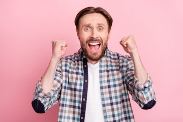 Naklejka premium Photo of young man happy positive smile rejoice victory champion goal fists hands isolated over pink color background