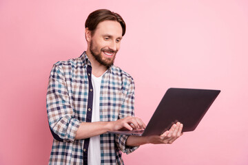 Profile side photo of young business man happy positive smile type email laptop isolated over pink color background